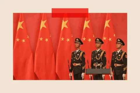 AFP via Getty Images Three soldiers stand in front of a Chinese flag