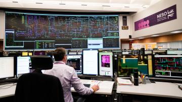 A worker in the National Grid control room in Sindlesham, Berkshire, overseeing the electricity supply.