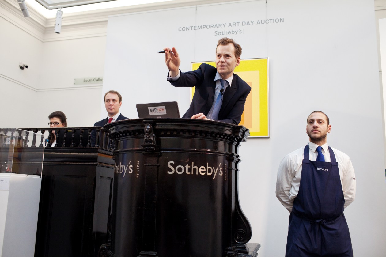 Olly Barker, an auctioneer at Sotheby's London, selling a piece of art at the contemporary art day auction.
