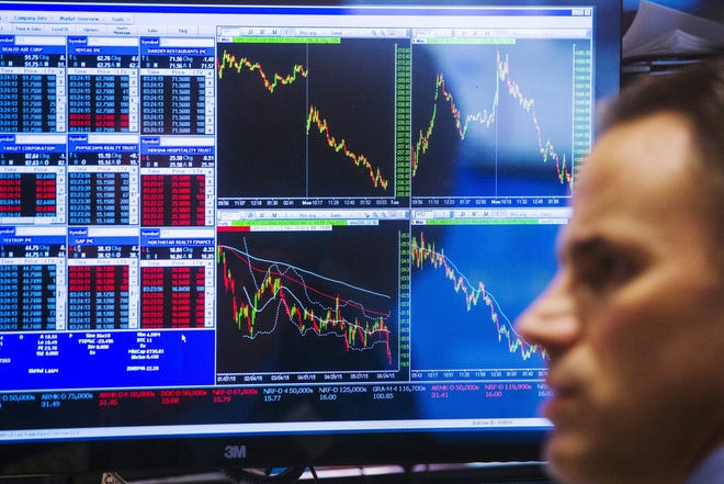 A trader works on the floor of the New York Stock Exchange shortly before the closing bell, June 29, 2015.