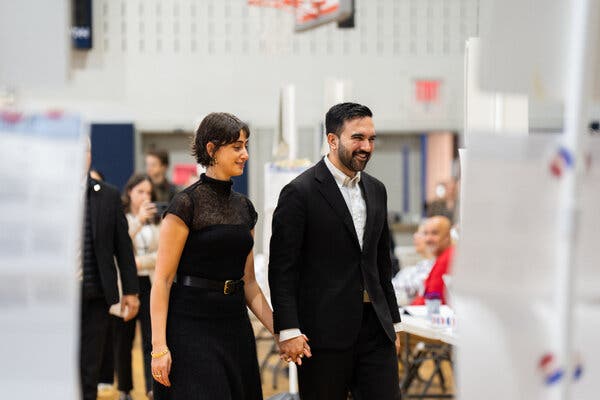 Mr. Mamdani holds hands with his wife as he prepares to vote on Election Day.