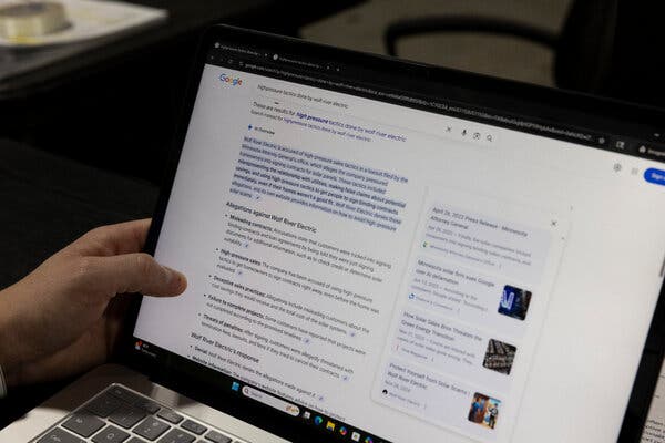 A left hand holds a screen showing a page of Google search results. 
