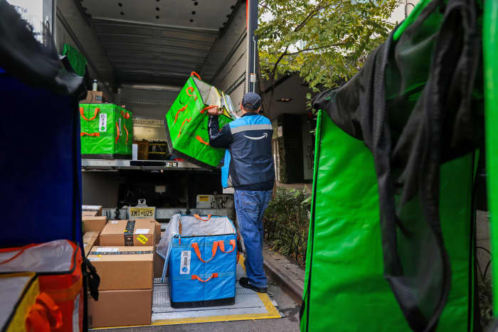 A worker sorts Amazon packages in New York.
