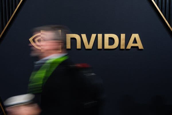 A blurry image of a man in front of an Nvidia sign.