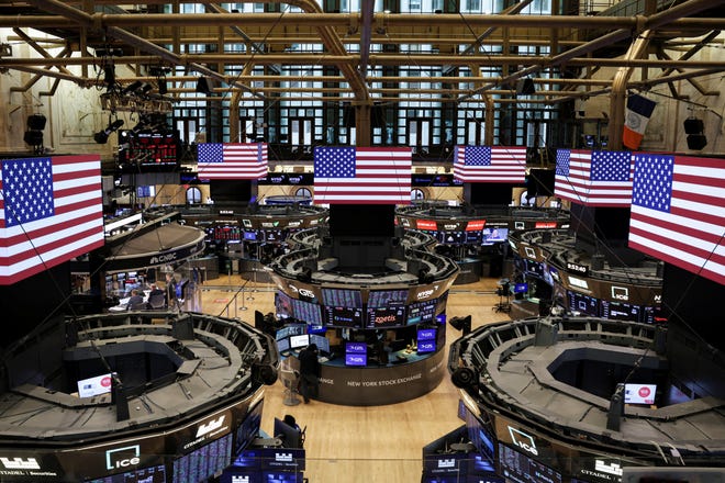American flags are displayed on screens on the floor at the New York Stock Exchange (NYSE) in New York City, U.S., September 22, 2025.