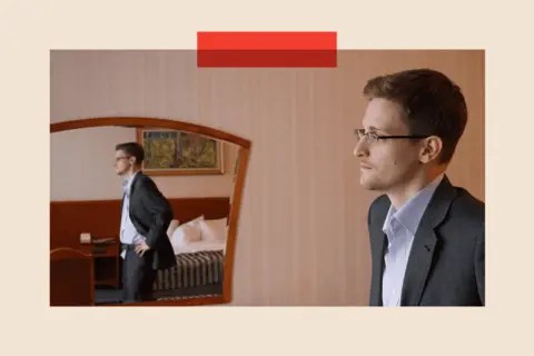 Getty Edward Snowden stands in a hotel room