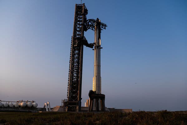 The giant Starship spacecraft on the launchpad at dusk.