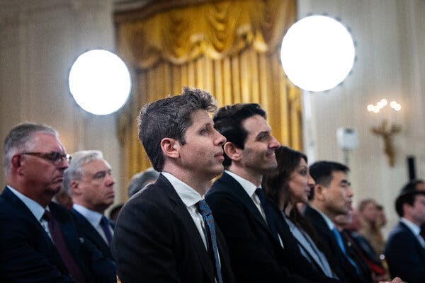 Sam Altman standing with a group of men and women all facing forward. 