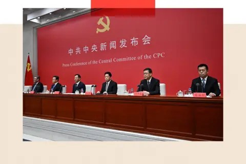 Getty Members of the CCP sit at a table in front of a red background.