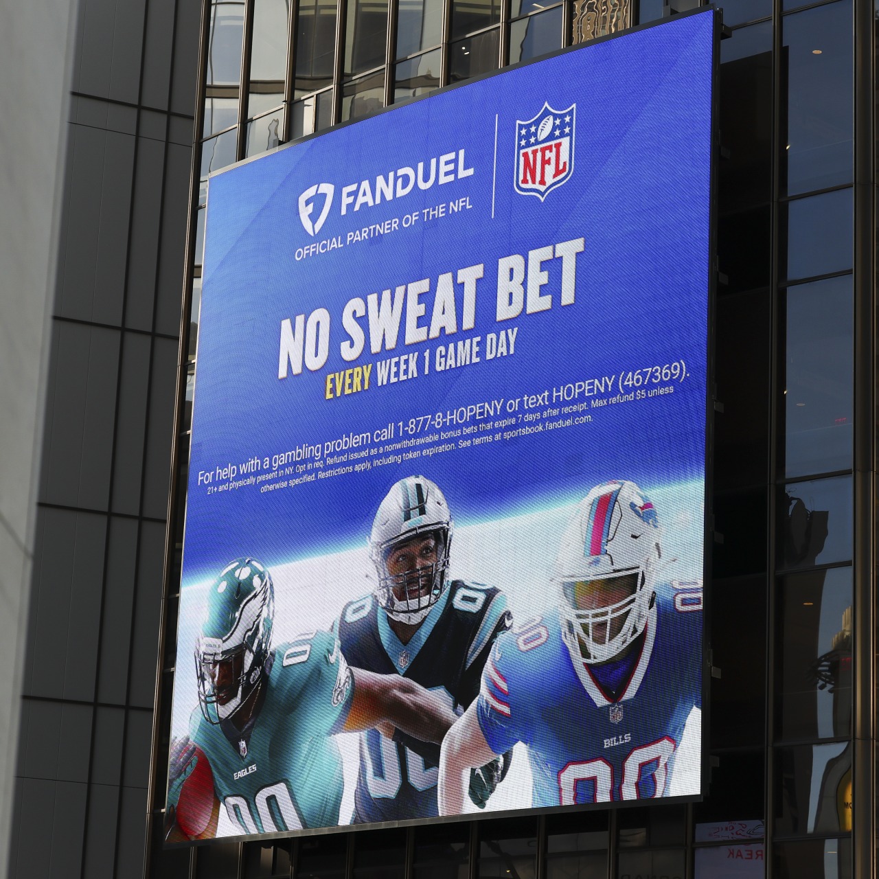 A FanDuel gambling advertisement featuring NFL players on the exterior of Madison Square Garden.