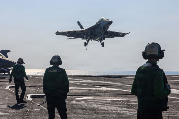 An F/A-18F Super Hornet landing on the USS Abraham Lincoln in the Arabian Sea.