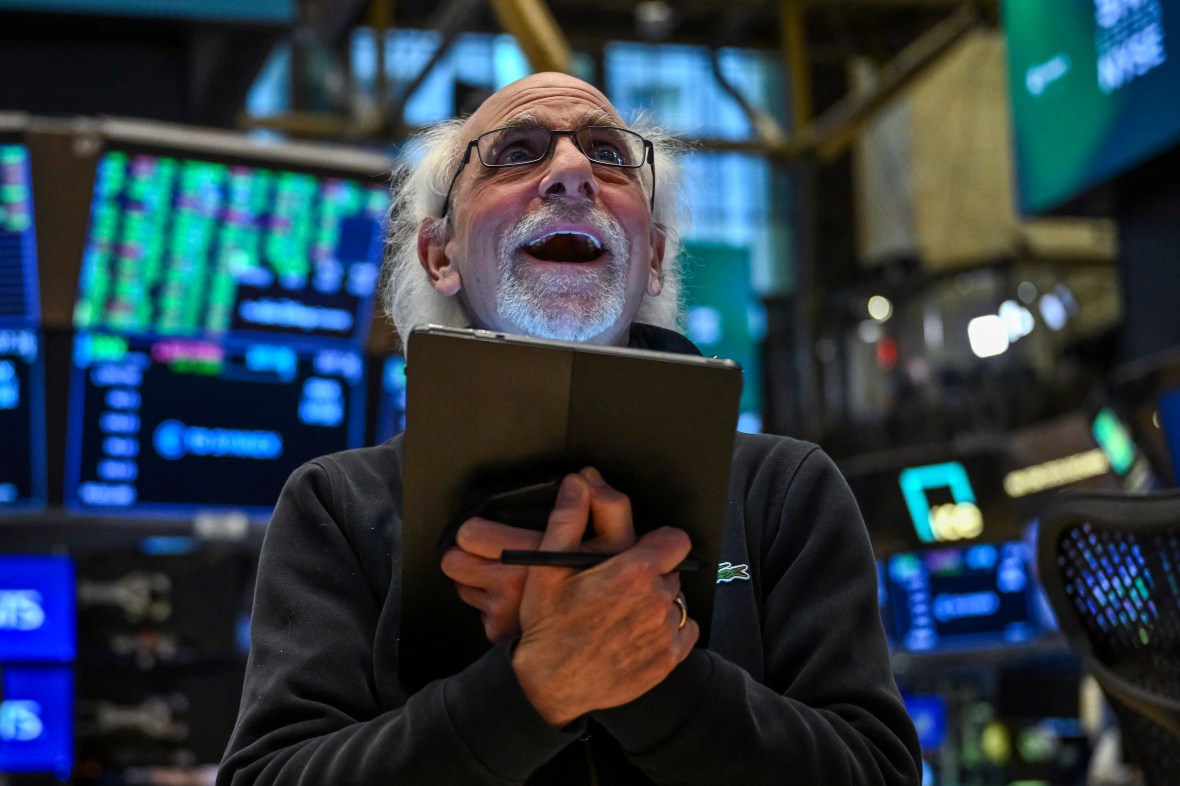 A trader looking upwards at the stock market board at the New York Stock Exchange.