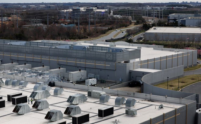 Cars drive by Digital Realty Data Center buildings in Ashburn, Virginia.