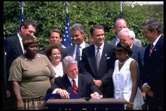 President Bill Clinton signing the welfare reform bill with former welfare recipients, VP Gore, Sen. John Breaux, and others present.
