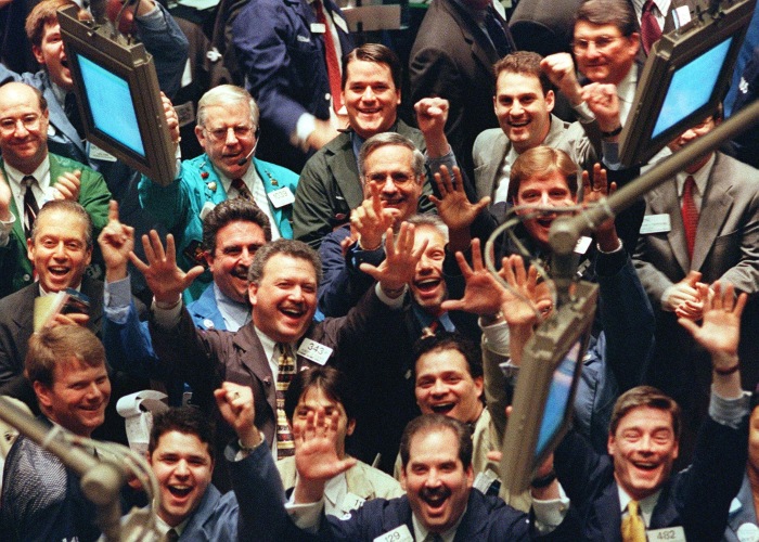 Traders cheering on the floor of the New York Stock Exchange.