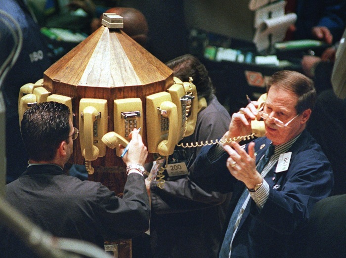 Traders talking on phones at the New York Stock Exchange.
