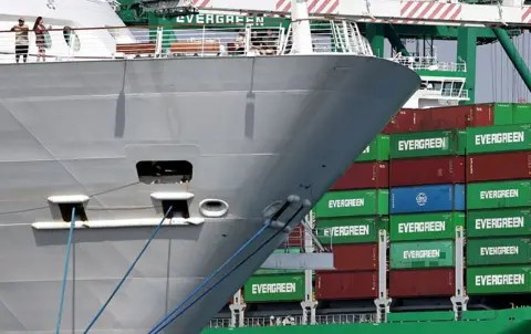 Getty Images Evergreen container ship loaded with shipping containers (R) at the Port of Los Angeles on September 26, 2025 in Los Angeles, California. 