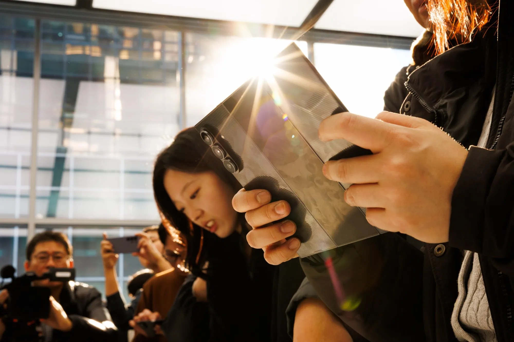 An attendee tries out a Samsung Electronics Co. Galaxy Z Trifold smartphone during a media preview in Seoul, South Korea.
