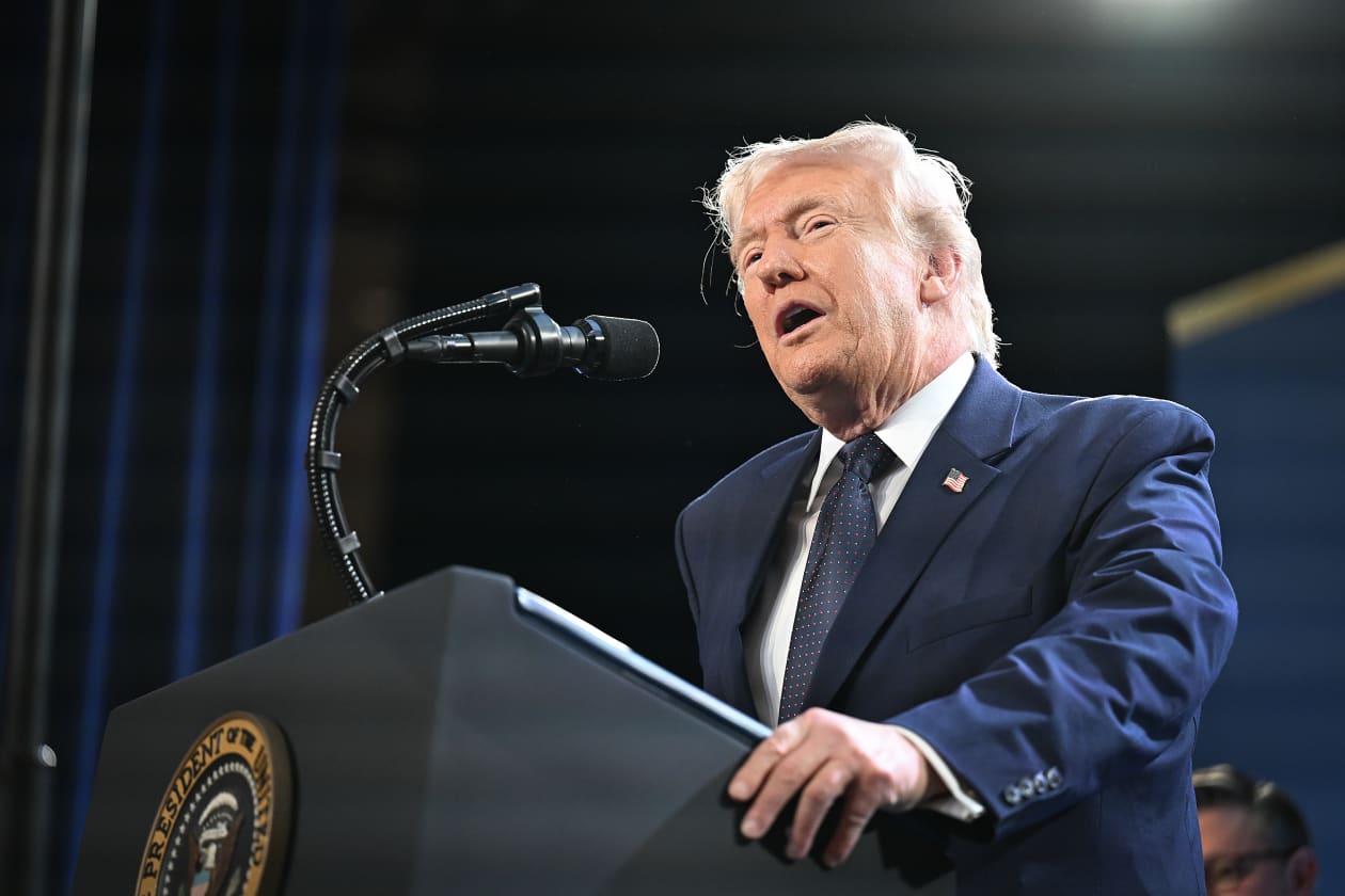Donald Trump speaking at a podium.