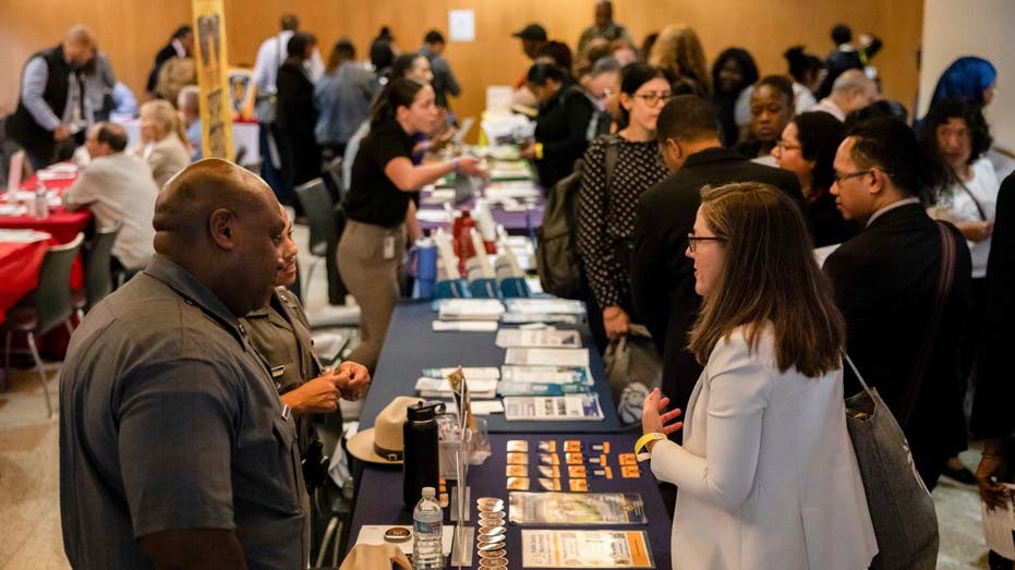 Job seekers and recruiters talk at a job fair
